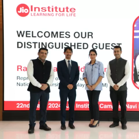 Staff and the guest pose for a photo