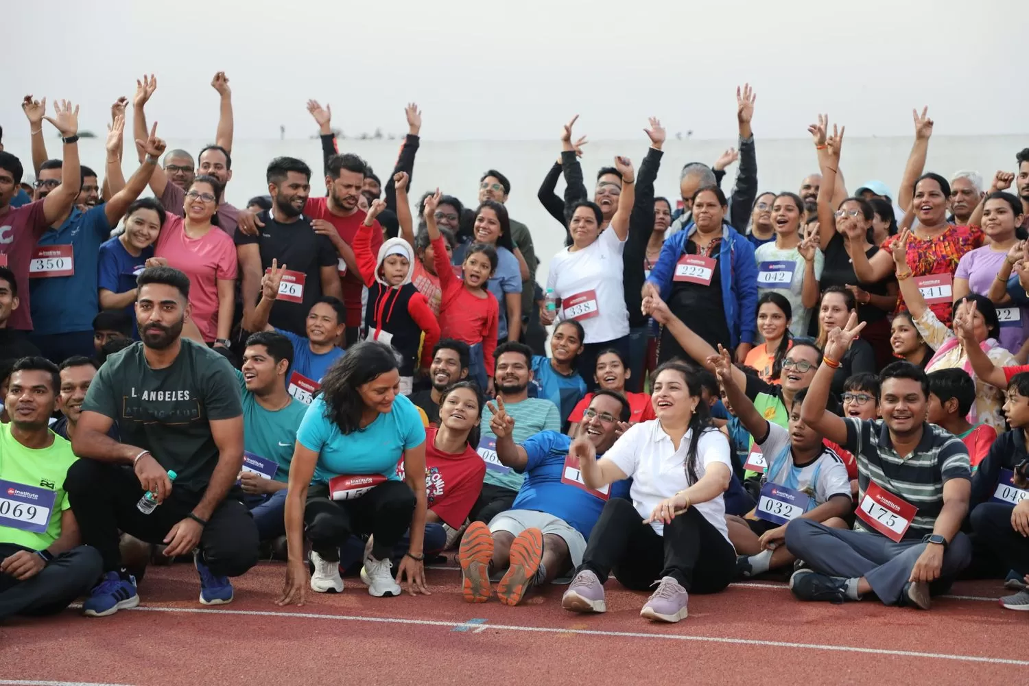 Participants and organizers posing after end of event