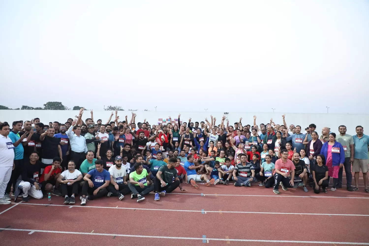 Participants and organizers posing after end of event