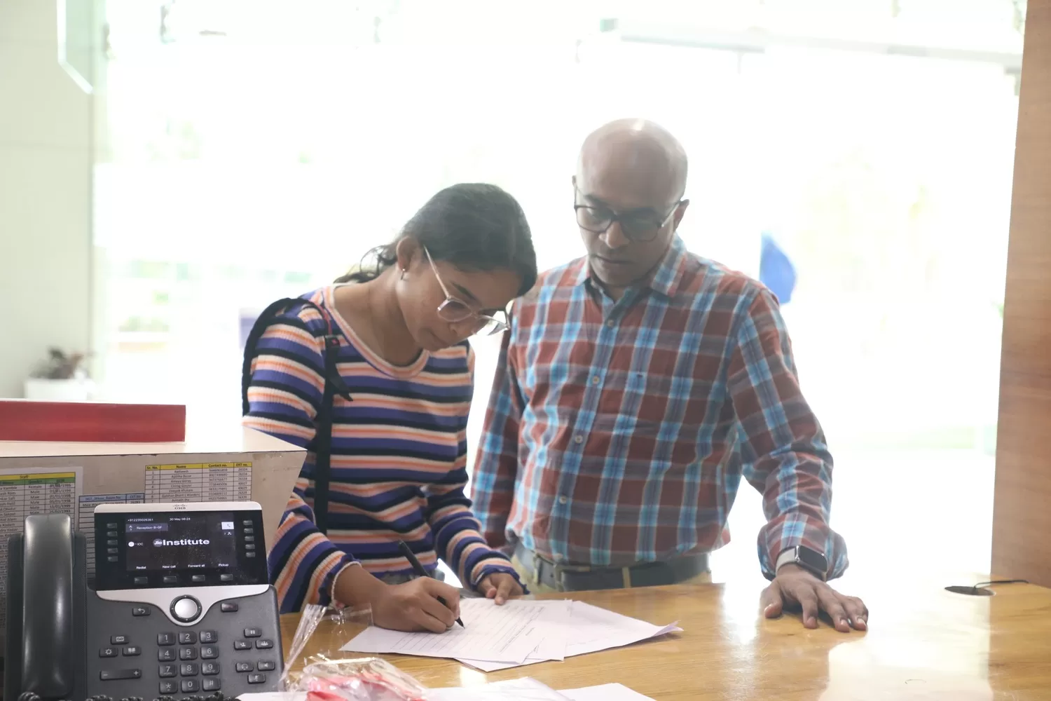 Student checking in accompanied by family