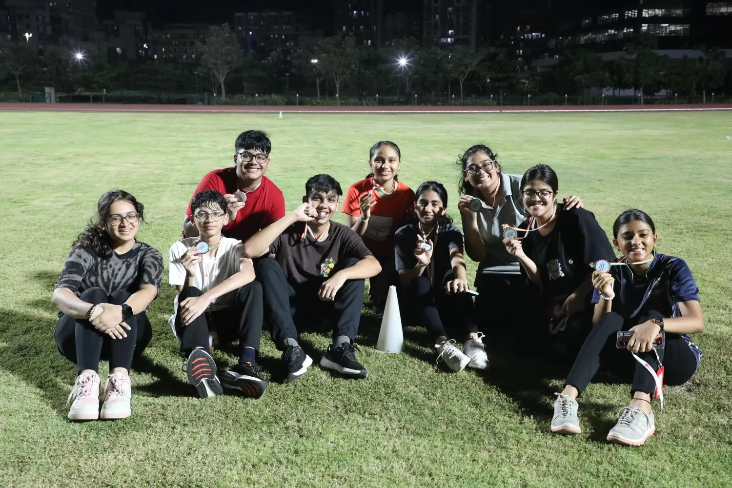 Team posing with medals after sport event