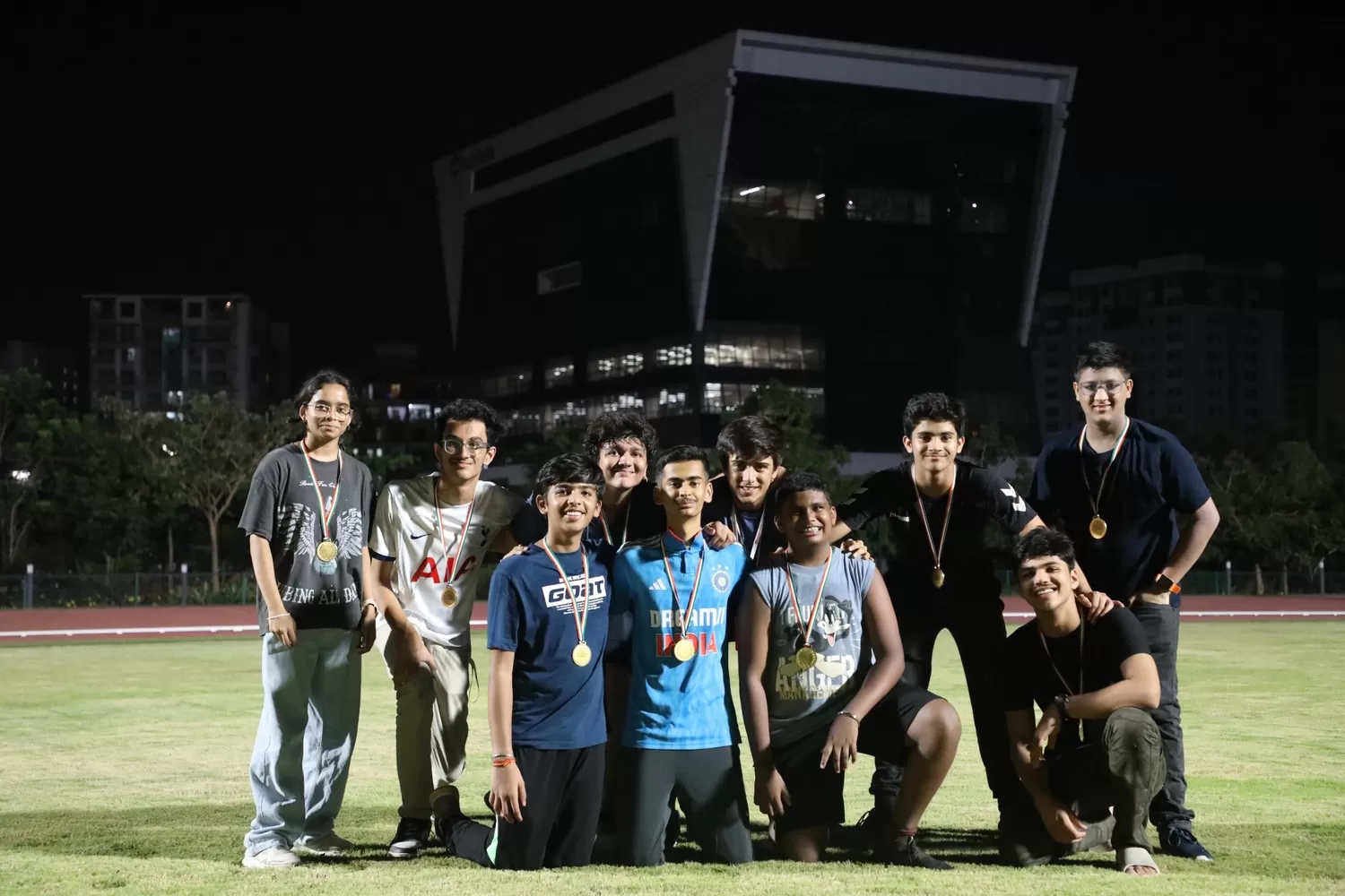 Team posing with medals after sport event