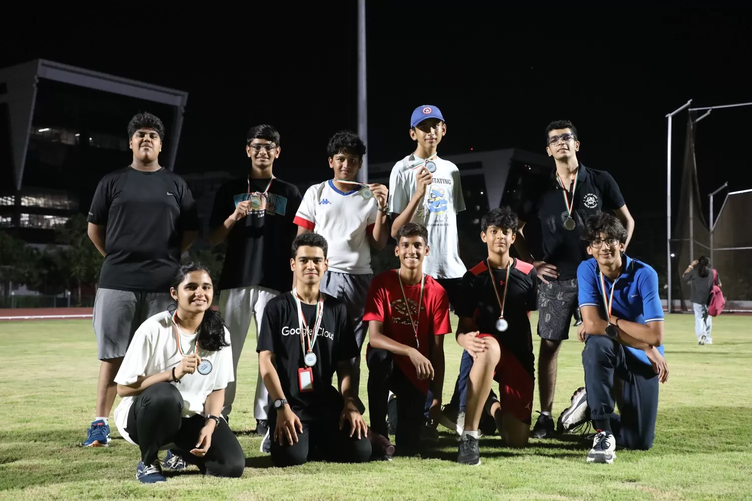 Team posing with medals after sport event